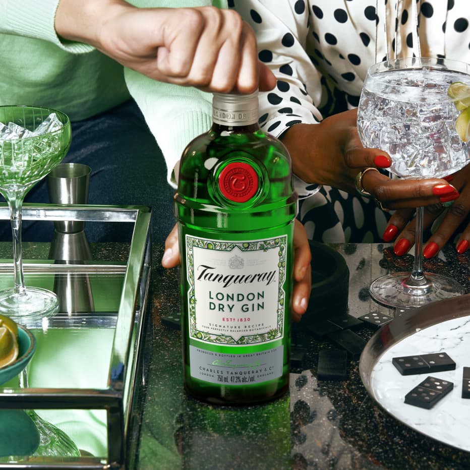 A bottle of London Dry on a table at a party.